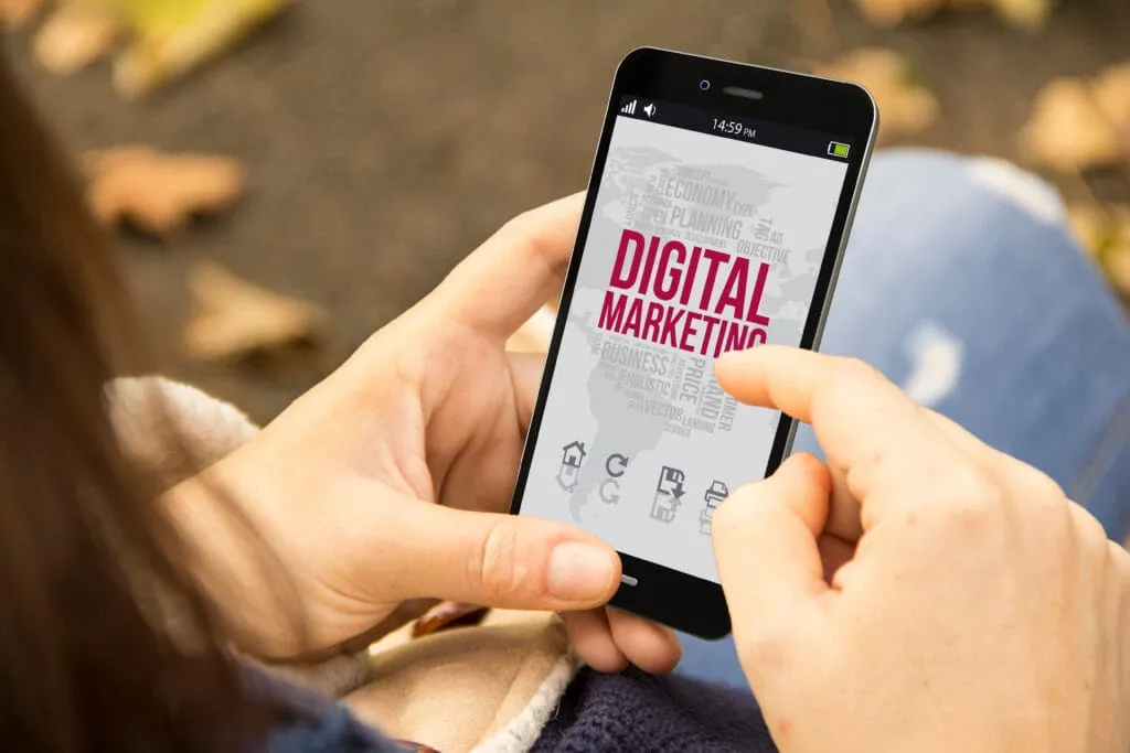 Telefon s nápisem Digital Marketing v rukou